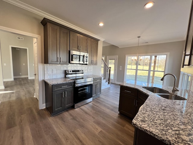 kitchen with dark brown cabinetry, light stone countertops, sink, and stainless steel appliances