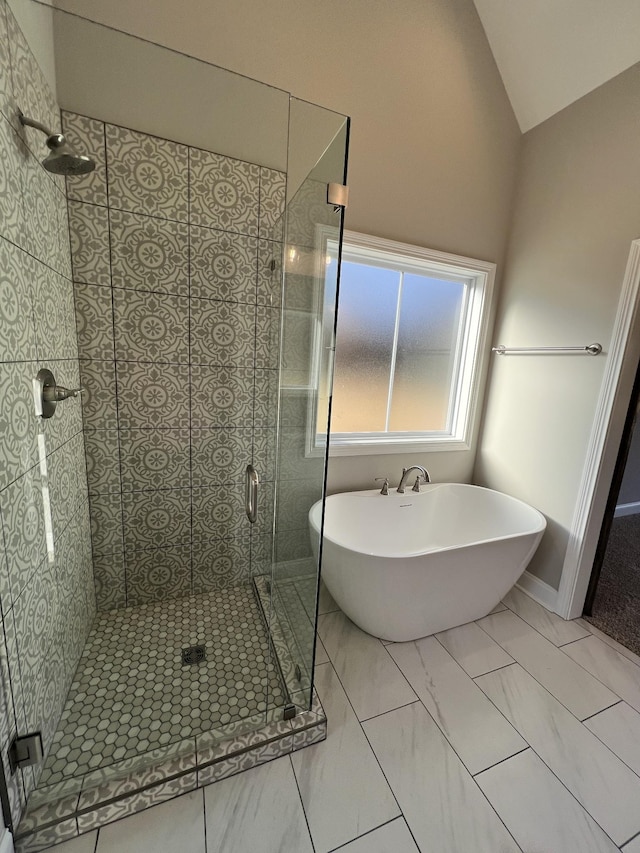 bathroom featuring independent shower and bath and vaulted ceiling