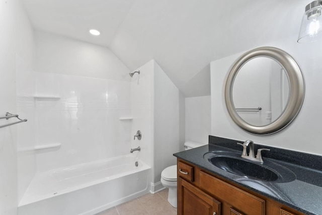 full bathroom with vanity, lofted ceiling, washtub / shower combination, tile patterned flooring, and toilet