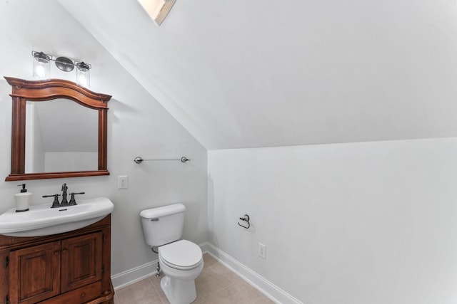 bathroom featuring tile patterned flooring, vanity, toilet, and lofted ceiling