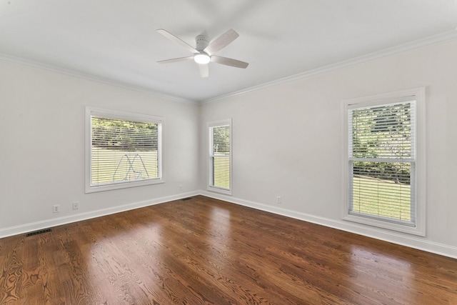 spare room featuring dark hardwood / wood-style floors, ceiling fan, and ornamental molding