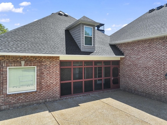 back of house featuring a sunroom and a patio