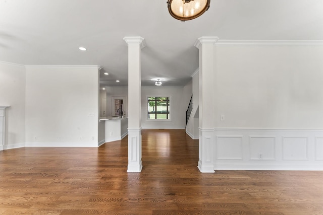 unfurnished living room featuring crown molding and dark wood-type flooring