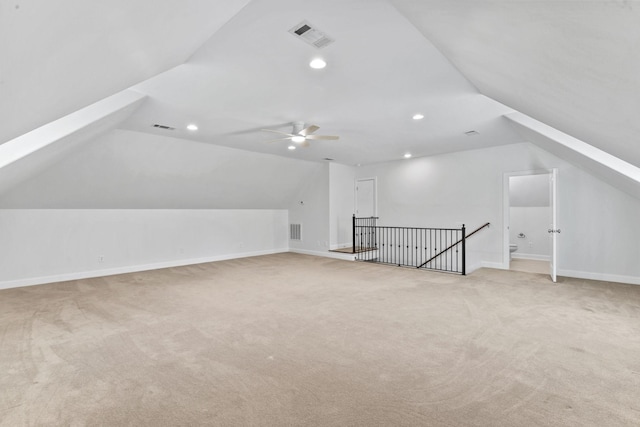 additional living space with light carpet, vaulted ceiling, and ceiling fan