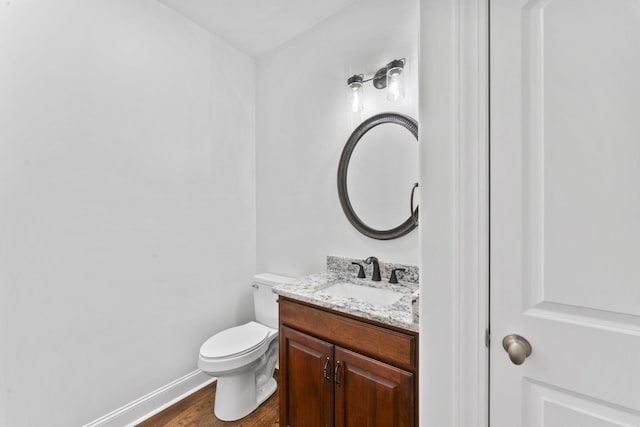 bathroom featuring hardwood / wood-style flooring, vanity, and toilet