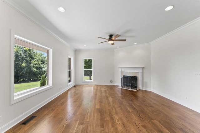 unfurnished living room featuring crown molding, a fireplace, ceiling fan, and dark hardwood / wood-style floors