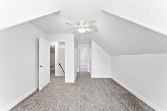 bonus room with ceiling fan, light colored carpet, and vaulted ceiling