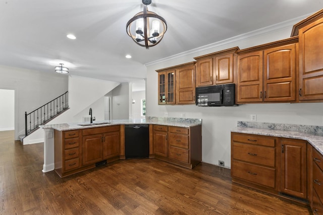 kitchen featuring black appliances, sink, decorative light fixtures, a notable chandelier, and kitchen peninsula