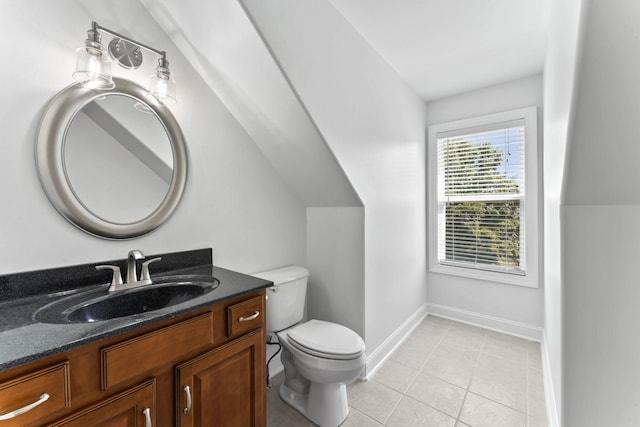 bathroom featuring tile patterned flooring, vanity, toilet, and vaulted ceiling