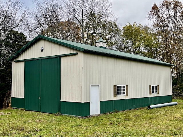 view of outbuilding featuring a lawn