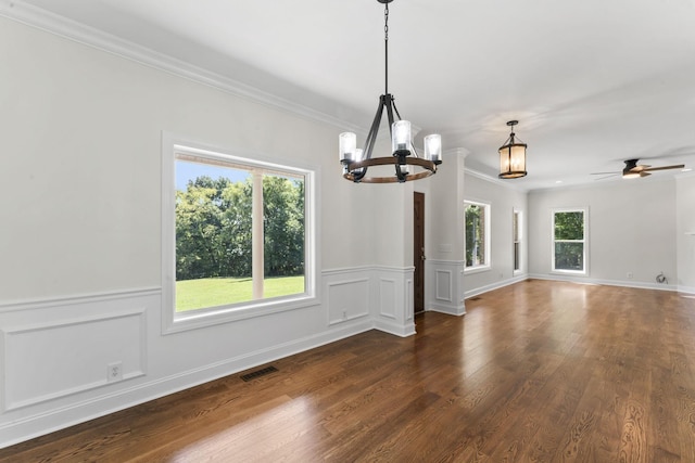 unfurnished dining area with dark hardwood / wood-style flooring, plenty of natural light, and ceiling fan with notable chandelier