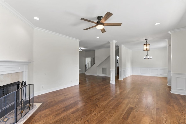 living room with a fireplace, dark hardwood / wood-style floors, ceiling fan, and ornamental molding