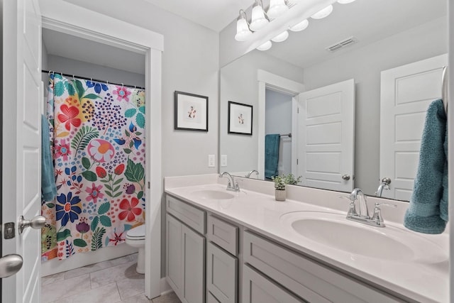 full bathroom with tile patterned flooring, vanity, shower / tub combo, and toilet