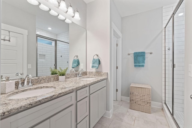 bathroom featuring tile patterned floors, vanity, and an enclosed shower