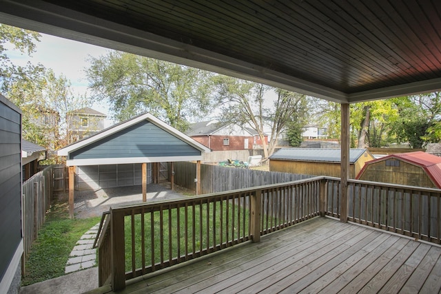 wooden deck featuring a lawn and a storage unit