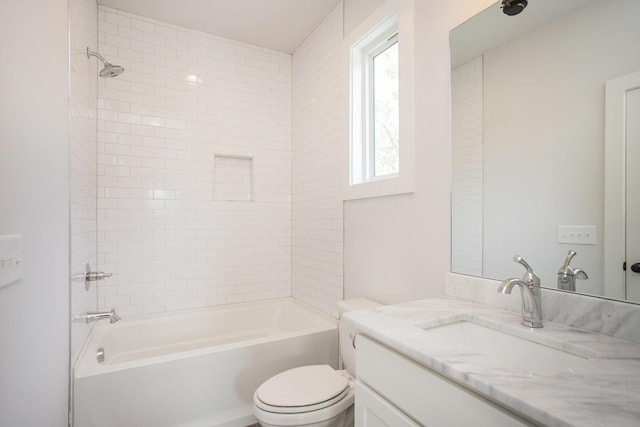 full bathroom with vanity, toilet, and tiled shower / bath