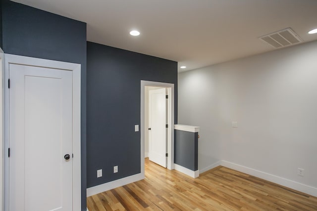 unfurnished bedroom with light wood-type flooring and a closet