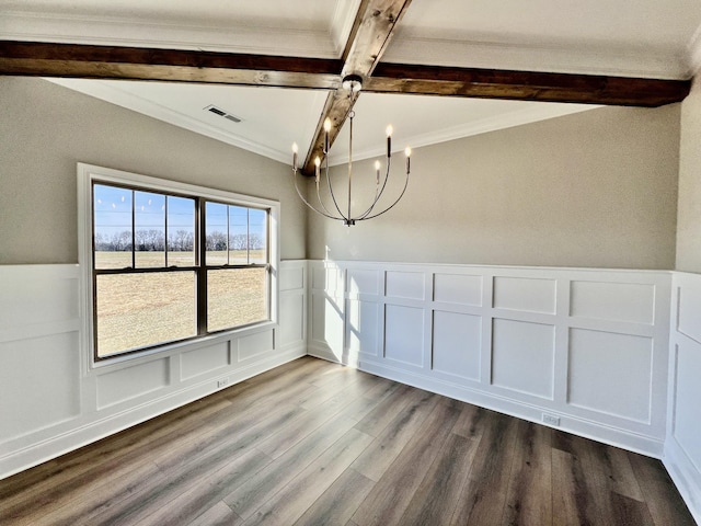 unfurnished dining area featuring beam ceiling, coffered ceiling, crown molding, hardwood / wood-style floors, and a chandelier