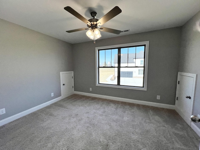 empty room with carpet flooring and ceiling fan