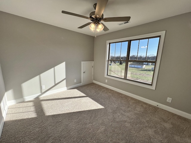 carpeted spare room with ceiling fan