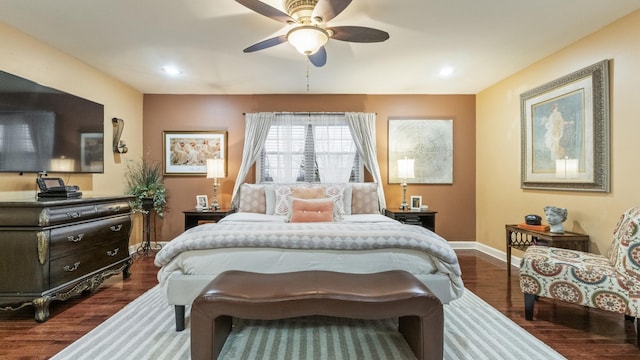 bedroom with ceiling fan and dark hardwood / wood-style floors