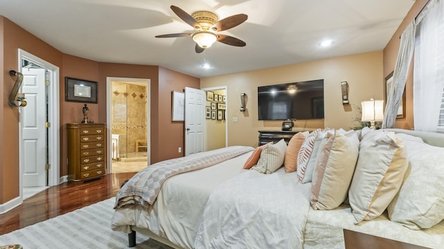 bedroom featuring connected bathroom, ceiling fan, and hardwood / wood-style flooring