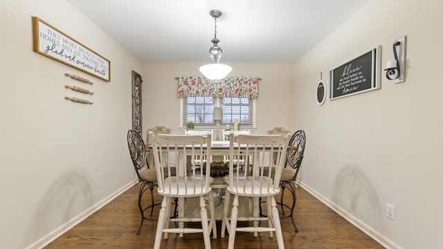 dining area with dark hardwood / wood-style flooring