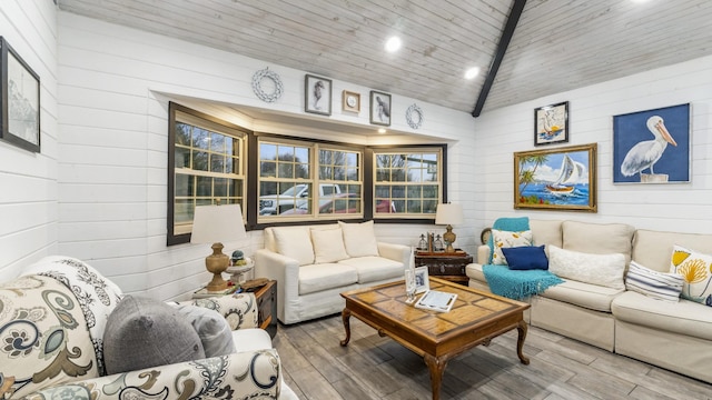 living room featuring hardwood / wood-style floors, wood walls, wooden ceiling, and high vaulted ceiling