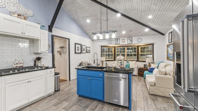 kitchen featuring white cabinets, pendant lighting, sink, and appliances with stainless steel finishes