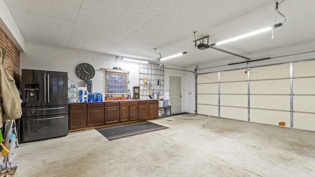 garage with black fridge and a garage door opener