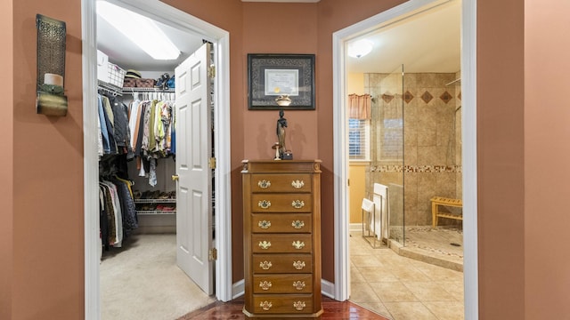 bathroom with tile patterned floors and a tile shower