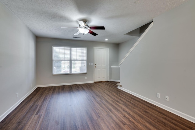 spare room featuring a textured ceiling, dark hardwood / wood-style floors, and ceiling fan