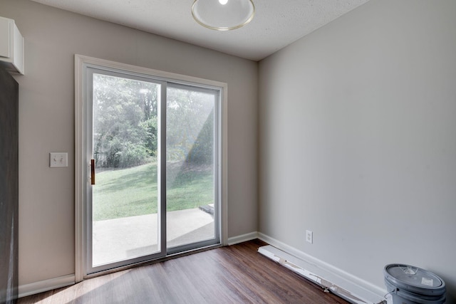 entryway featuring a textured ceiling and dark wood-type flooring