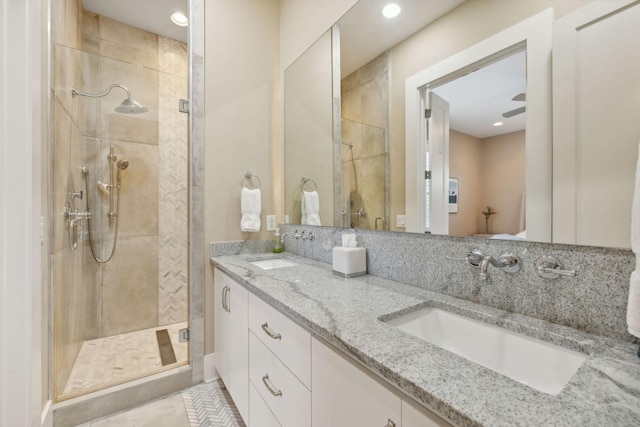 bathroom featuring walk in shower, vanity, and ceiling fan