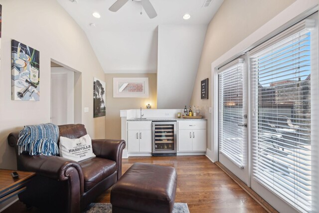 bar with wine cooler, ceiling fan, dark hardwood / wood-style floors, white cabinetry, and lofted ceiling