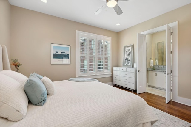 bedroom with ceiling fan, ensuite bathroom, and dark hardwood / wood-style floors