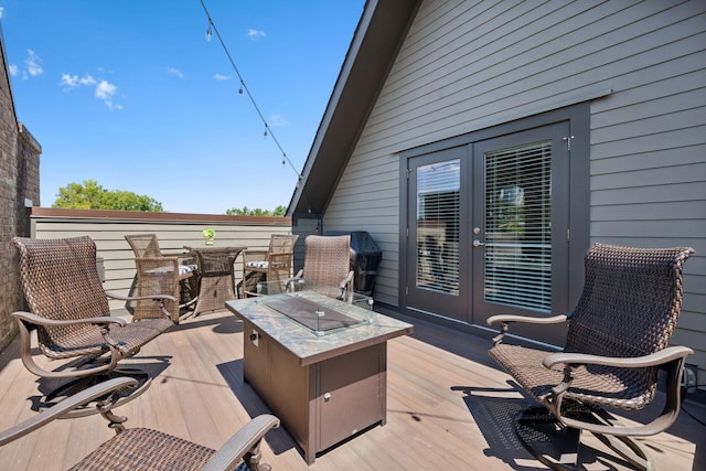 deck with french doors and a fire pit