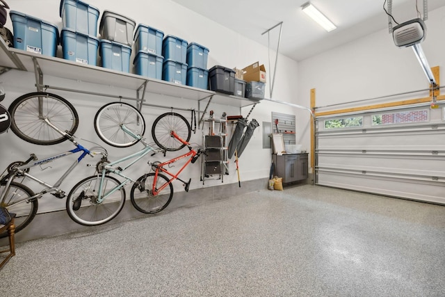 garage with electric panel and a garage door opener