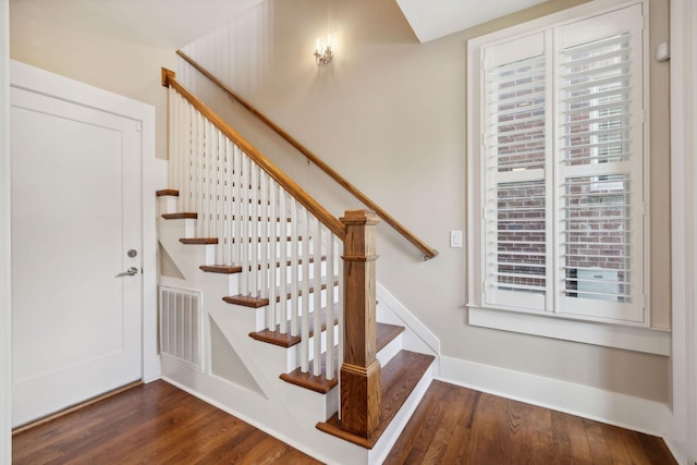 stairway with hardwood / wood-style floors