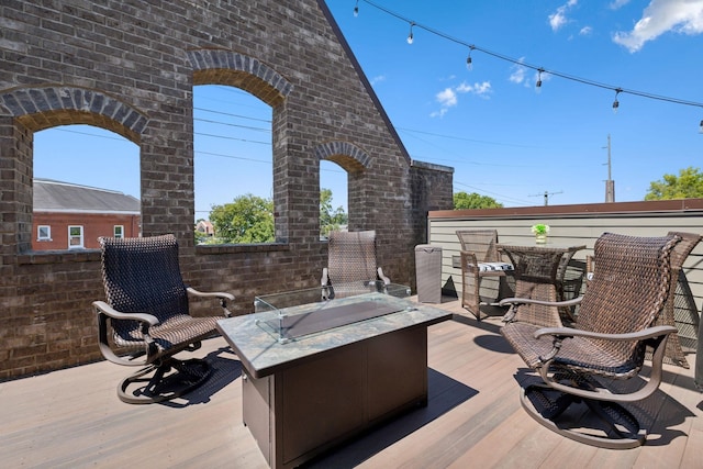 wooden terrace featuring a fire pit