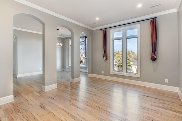 empty room with light wood-type flooring and crown molding