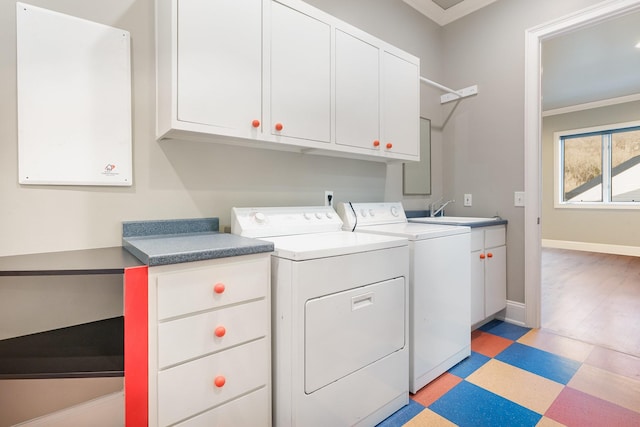 washroom featuring cabinets, separate washer and dryer, ornamental molding, and sink