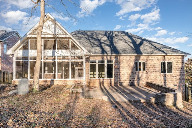 rear view of house with a sunroom and a patio