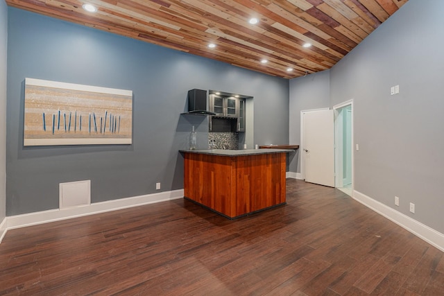 interior space with decorative backsplash, wooden ceiling, dark wood-type flooring, and wall chimney range hood