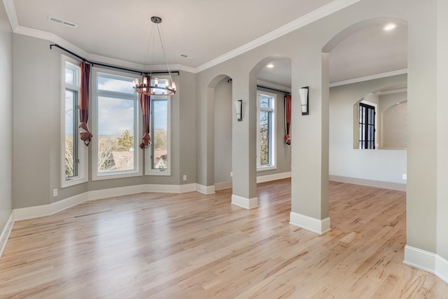 unfurnished dining area with a notable chandelier, light hardwood / wood-style floors, and crown molding