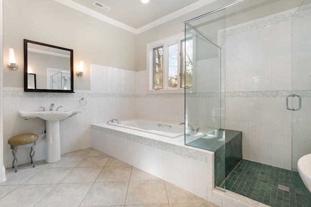 bathroom featuring tile patterned floors, shower with separate bathtub, ornamental molding, and tile walls