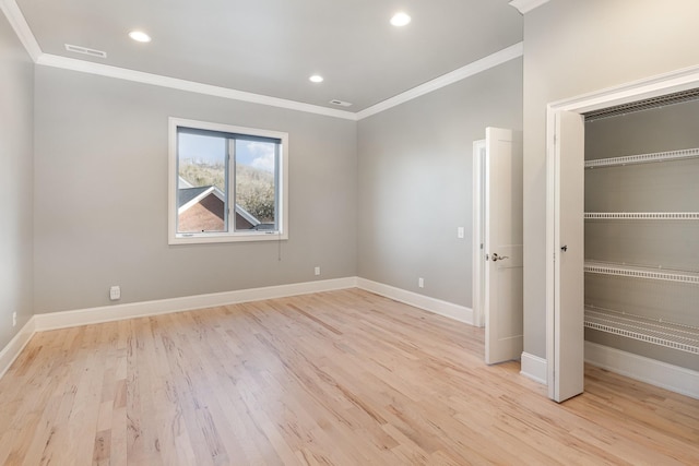 unfurnished bedroom featuring a closet, light hardwood / wood-style flooring, and ornamental molding