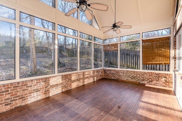 unfurnished sunroom with ceiling fan and vaulted ceiling