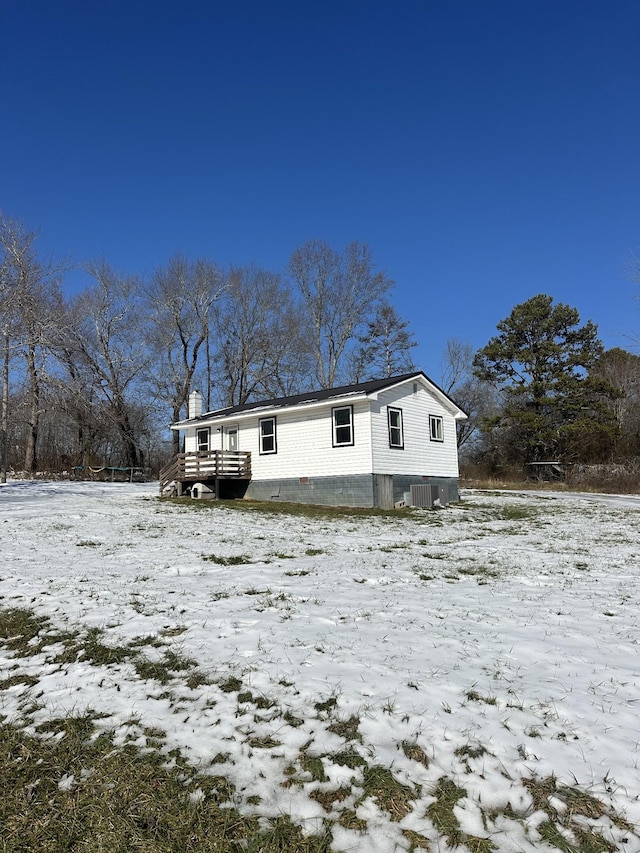 view of snow covered back of property