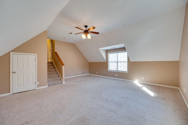 additional living space with ceiling fan, light carpet, and lofted ceiling